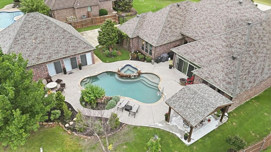 Looking for a 4-bed single family home with a pool, guest house, sunroom, gazebo, and exceptional garage space? This Fort Worth property offers 3,401 square feet, 4 full baths, a 0.647-acre lot, attached 3-car garage, additional oversized 2-car garage, and a 415-square-foot guest house.

Welcome to 1316 Durango Springs Drive in Fort Worth, a custom traditional home in the highly desirable Spring Ranch Addition within Northwest ISD. Set on a landscaped interior lot with mature trees, sprinkler system, wood and wrought iron fencing, and a spacious backyard, this property is built for flexible living, entertaining, storage, and everyday comfort. Inside, the open living area features vaulted ceilings, a stone fireplace, built-in cabinetry, wood floors, and large windows that bring in natural light and backyard views. The kitchen offers granite counters, breakfast bar, island, pantry, gas cooktop, built-in cabinetry, eat-in space, and a natural connection to the dining, living, and sunroom areas. The private primary suite includes a sitting area, dual sinks, garden tub, separate shower, separate vanities, linen storage, and walk-in closet. A split-bedroom layout adds privacy, while additional bedrooms include walk-in closets and flexible bath access. The home also includes a large utility room with built-ins, drip-dry area, freezer space, and full-size washer and dryer area. Outdoors, enjoy a resort-style pool with safety cover and spa, covered patio, garden areas, gazebo, several beautiful trees including fruit trees, Fire Pit, Horseshoe pit and a 415-square-foot guest house for flexible use. Vehicle, hobby, and storage needs are well served by the attached oversized 3-car garage plus an additional oversized 2-car garage with workshop potential, epoxy flooring, garage openers, RV or boat parking, and extra storage. This 4-bed single family home in Spring Ranch also offers community access to a park, playground, perimeter fencing, and HOA-managed facilities.