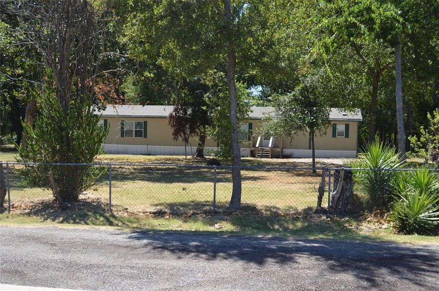 This 3 BR 2 Full Bath manufactured home is nestled on a nearly 1 acre treed lot.  The property is off the busy highway on a quiet circle road with wonderful shade trees for peaceful enjoyment.  The home is recently updated with new floors and paint, featuring a large MBR with ensuite bathroom. The master bathroom features a tub, separate shower and dual vanity areas with walk-in closets.  The kitchen has built-in appliances, including a refrigerator and center island.  Lots of cabinetry, including a hutch in the dining area.  This home is eligible for financing and will provide all of the amenities you are looking for in a tranquil setting.