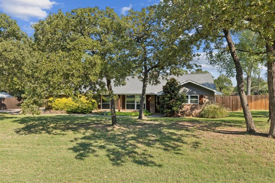 MASSIVE .6+ ACRE LOT IN KELLER ISD! NO HOA! BEAUTIFUL UPDATES THROUGHOUT! Nestled in a serene, established community, this impressive 1.5-story residence radiates timeless charm and modern sophistication. Mature trees, manicured landscaping, and stately curb appeal set the tone, while inside, thoughtful updates and upgrades elevate every space.

The home’s elegant interior has been fully repainted (2021) and showcases wood-look flooring, crown molding, and abundant natural light. A 2019 full remodel transformed the kitchen into a masterpiece, featuring white cabinetry, a striking tile backsplash, stainless steel appliances, and a 5-burner cooktop with vent hood, and a pot filler. The massive walk-in pantry with custom cabinetry and counterspace is truly unmatched. The kitchen flows into the living room, where vaulted wood-beamed ceilings, a gas fireplace, and custom built-ins with floating shelves create a luxurious gathering space.

Retreat to the primary suite, freshly updated with recent carpet (2025), a sliding barn door, spa-like ensuite with a dual vanity, pendant lighting, and a custom walk-in closet system. Secondary bedrooms are equally versatile—one with dual closets and built-ins, another with LVP flooring (2023), and a flexible 4th bedroom or office with walk-in closet. Upstairs, a sprawling game room with walk-in closet and full bath offers endless lifestyle options.

Outside, the huge backyard is a quiet oasis, enhanced by mature fruit trees (2 peach, 1 plum, 1 fig) and raised garden beds. The property also offers an automated 13-zone sprinkler system with rain sensor.

Additional highlights include a 2019 tankless water heater and majority home automation, including smart switches and exterior lighting. With NO HOA, Keller ISD schools, and a prime location close to shopping and dining yet tucked away for peace and quiet, this home is a rare blend of comfort, elegance, and modern convenience.