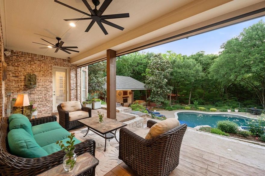 Tucked beneath a canopy of mature trees in Southlake’s prestigious Kirkwood Hollow, this stunning residence offers a seamless blend of timeless design and thoughtful updates. Backing to a peaceful creek, the home is set on a park-like lot that delivers resort-style living in a serene natural setting. Every detail has been refreshed with warmth and sophistication—from new paint, floors, and fixtures to custom lighting and a brand-new roof installed in 2023. The grand iron and glass entry sets the tone, opening to a private study, formal dining with a butler’s pantry, and a spacious family room with walls of windows framing the picturesque outdoors—ideal for effortless entertaining. The light-filled chef’s kitchen is a true centerpiece, showcasing new quartz countertops, stainless steel appliances including a GE convection double oven and gas cooktop, a wine fridge, planning station, and generous space open to both dining areas. With 5,776 square feet, the home features 5 bedrooms, 5 full and 1 half baths, and an oversized 3-car garage. The first-floor primary suite offers a tranquil retreat, while a separate guest suite and full laundry room are thoughtfully placed on the opposite wing for privacy. Upstairs, enjoy a spacious game room, dedicated media and fitness rooms, and three uniquely styled bedrooms each with en-suite baths. Step outside to a tiered stone patio overlooking a private backyard oasis—perfect for alfresco dining, bocce or basketball, and relaxing by the sparkling pool and spa. Lush landscaping and mature trees frame the view, creating an atmosphere of pure tranquility. Ideally located in top-rated Carroll ISD school district, upscale shopping and fine dining.