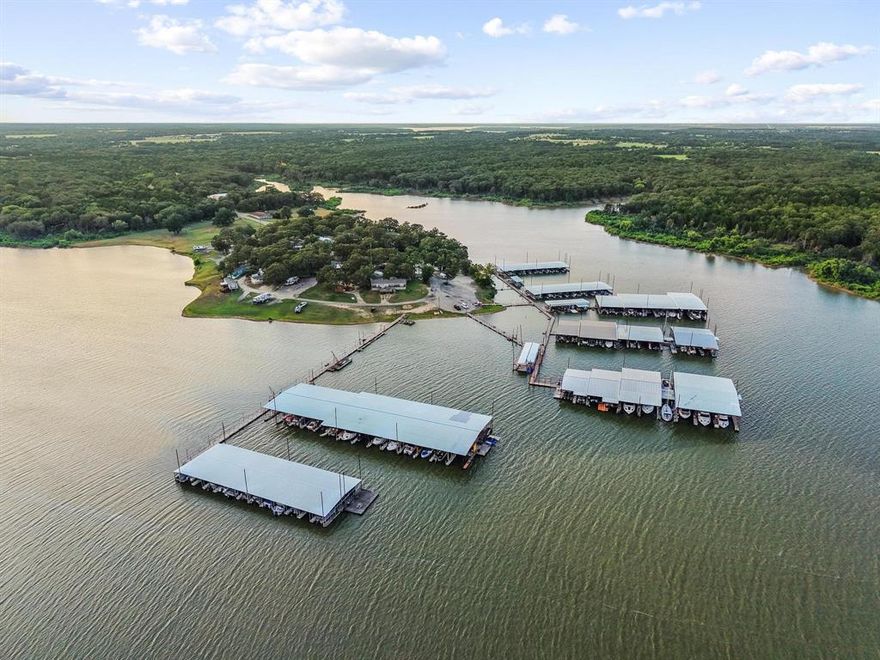 A LIFE WELL LIVED is a LIFE AT THE LAKE! Are you a lake lover that is tired of paying for hotels or overpriced Airbnb's? Are you a snowbird looking to escape the brutal winters of the north? Then, look no further than this second-owner home located in Walnut Creek Resort, just a short golf cart ride from the water’s edge. Perched at one of the highest elevations in the resort, you'll have peace of mind knowing your home is safe from flooding. This Solitaire home comes fully furnished—including a washer, dryer, refrigerator, grill, and adorable patio furniture—so all you need to bring is your toothbrush. Inside, you'll find an oversized primary suite with a walk-in closet and a luxurious soaker tub, along with an eat-in kitchen that features a peninsula with barstool seating and a full-sized dining area. With high-speed fiber Internet, you can easily work remotely while enjoying vacation life. The home features a durable metal roof, built to last through the seasons, and oversized cedar decks, which were re-stained five years ago and are perfect for relaxing or entertaining. Walnut Creek Resort is a gated community that offers a full-service marina with 170 covered boat slips and boat ramp as well as fun community events that bring neighbors together and celebrate the American spirit! This property comes with a boat slip for a separate fee. Inquire about different size slips available. Located just 10 minutes from Willis Bridge, the new Megastar Casino, and popular Pelican’s Landing Restaurant, this vacation property offers everything you need for lake living and is open to part-time residents. So, what are you waiting for? Rent a kayak from the marina and spend the day exploring your new lakeside playground!