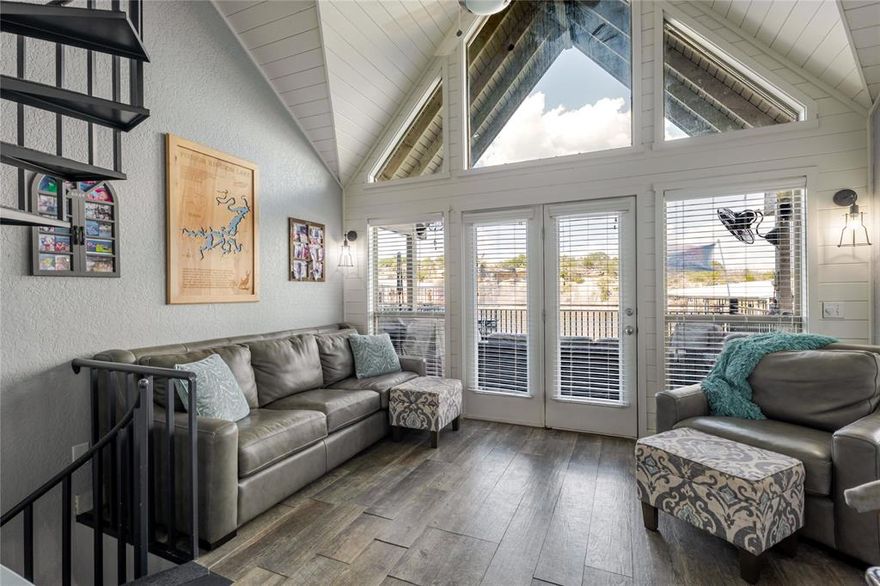 Lakefront Luxury Cabana! Wake up to the sound of the gentle waves against the shore. This waterfront cabana sits just steps from Possum Kingdom Lake, the water is literally a stone’s throw from your bed. Included with this property is a 40ft BOAT SLIP in Bluff Creek Marina, giving you effortless access to the lake for a quick cruise, sunset ride, or day on the water. Updated and move-in ready, this two-bedroom, two-bath retreat blends comfort and modern design. Vaulted ceilings and panoramic windows flood the living space with natural light, while the open layout connects the kitchen, dining, and living areas for easy entertaining. The kitchen features granite counters, stainless steel appliances, and custom cabinetry. Step outside onto your private balcony and take in sweeping lake views. The spacious primary suite offers a peaceful getaway, while the guest bedroom provides flexibility for visitors or family. Both bathrooms are tastefully renovated with stylish fixtures and finishes. Owners at Sportsman’s World enjoy an unmatched lake lifestyle with community amenities that include a swimming pool, tennis courts, playground, marina, and general store. This is your chance to own one of PK’s most desirable lakefront escapes—complete with a 40-ft boat slip and front-row access to the water. Short-term rentals are not permitted.