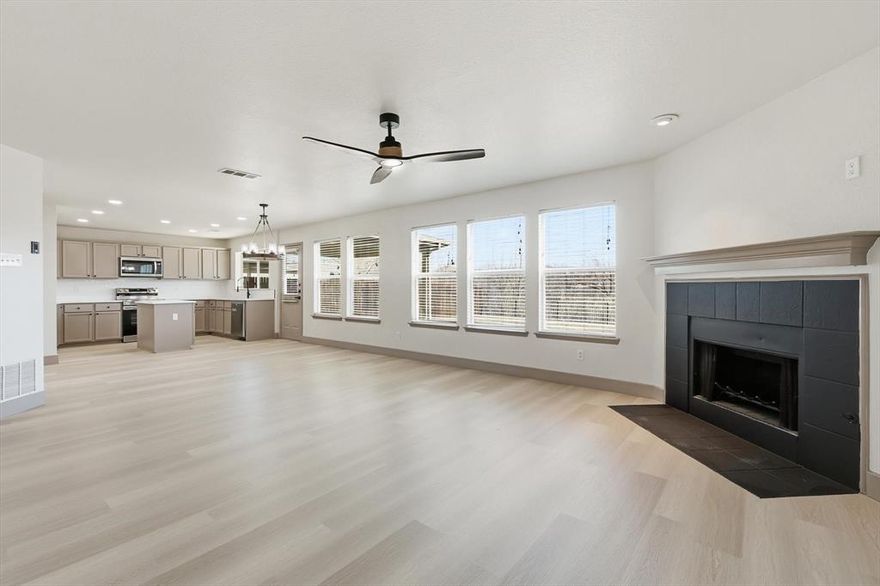 Just Updated Spacious 5-bedroom, 2.5-bath home located in the desirable Liberty Crossing community of Fort Worth. Built in 2005, this rare 5 bed room traditional-style residence offers over 2,450 square feet of thoughtfully designed living space with a functional and versatile floor plan ideal for everyday living and entertaining. The interior features expansive living and dining areas filled with natural light, highlighted by a cozy gas fireplace that serves as a focal point of the main living space. The kitchen is well appointed with granite countertops, ample cabinetry, stainless steel appliances, and generous counter space, providing both functionality and storage. The flexible layout includes five generously sized bedrooms, offering options for guest rooms, home offices, or additional living space. The primary suite provides a private retreat with an en-suite bathroom and ample closet space. Flooring throughout the home includes a combination of luxury vinyl plank and carpet, offering both durability and comfort. Exterior features include classic curb appeal, a covered patio or porch ideal for outdoor relaxation, and a private backyard enclosed by wood and wrought-iron fencing. The property also includes an attached two-car garage with driveway parking. Situated on a greenbelt lot, the home offers added privacy and a peaceful outdoor setting. Residents enjoy access to community amenities including a clubhouse and swimming pool. Conveniently located within Eagle Mountain–Saginaw ISD and close to shopping, dining, schools, and major commuter routes, this home presents an excellent opportunity to own a spacious property in a well-established Fort Worth neighborhood.