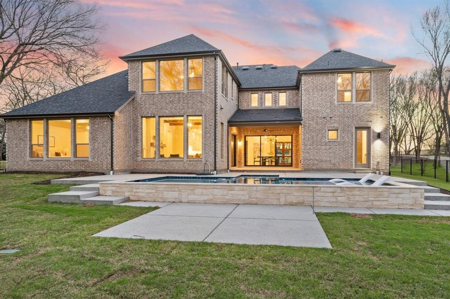 Welcome to this stunning 2025-built Drees Custom Home, perfectly situated on a spacious .812-acre corner lot in the established Ravenwood Addition. Offering 4 bedrooms, 5 bathrooms, and a 3-car garage with a desirable 2+1 configuration, this home blends modern luxury with thoughtful design. Step inside to soaring ceilings, abundant natural light, and beautiful hardwood floors that guide you through a private front office and into the expansive open-concept living, dining, and kitchen areas. Designed for both everyday living and entertaining, the chef’s kitchen features a striking waterfall island with Calacatta quartz countertops, soft-close cabinetry, a 6-burner commercial-grade gas cooktop, dual convection ovens, and a fully equipped prep kitchen with its own electric cooktop, sink, and extensive pantry shelving. The primary suite is conveniently located on the first floor and serves as a true retreat, complete with an oversized walk-in closet and a spa-inspired bathroom featuring a Hollywood soaking tub, dual vanities, and a spacious walk-in shower with multiple shower heads. The elegant utility room connects directly to the primary suite and includes a large sink and front yard views. A secondary bedroom with a full bath downstairs provides ideal accommodations for guests or multigenerational living. Upstairs, you’ll find a spacious game room, dedicated media room, and a versatile flex space perfect for a fifth bedroom, hobby room, or additional storage. Seamlessly blending indoor and outdoor living, large sliding glass doors open to your private backyard oasis. Enjoy a heated Claffey pool and spa with tanning ledge and LED lighting, a pool bath with exterior access, additional patio space ready for an outdoor kitchen, and a Hunter Hydrawise smart sprinkler system. This exceptional home offers luxury, functionality, and resort-style living all in one, an opportunity you won’t want to miss.