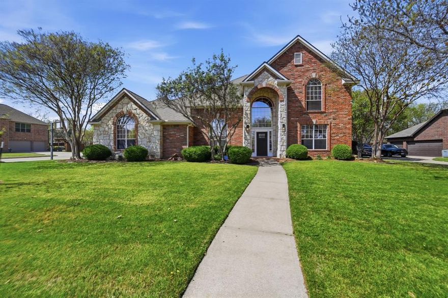 This spacious home with a stately stone and decorative brick facade sits on a premier .46-acre corner lot in the established Overton Ridge neighborhood of Keller. The home is showcased by an expansive private backyard oasis with a covered patio and sparkling saltwater 38K-gallon diving pool; ideal for relaxing, entertaining, and year round play. Designed for comfortable everyday living, the functional, two-story floor plan offers a formal living room or optional study, an elegant dining area, an oversized family room with a traditional gas fireplace and wall of windows, four generously sized bedrooms with walk-in closets, three full and one half baths, a second-level game room, a utility area, and an attached three-car garage. The chef's kitchen features an abundance of cabinets and prep space, a breakfast bar, center island, gas cooktop, double ovens, and a sunny breakfast nook with windows overlooking the backyard. Privately situated on the 1st level of the home, the primary suite provides a peaceful escape with a charming sitting area before bay windows and a spa-inspired bath highlighted by quartz counters. Rich hardwood flooring, custom built-ins, tall ceilings, gracious windows, and a large walk-in attic with Radiant Barrier insulation add comfort and efficiency throughout the home. Additional amenities of the home include a newer roof, upgraded carpet and tile floors, fresh paint in select rooms, and a replaced AC serving the primary suite. Overton Ridge residents enjoy access to a neighborhood park and heavily treed walking paths. This home feeds the award-winning Keller ISD and is located with close proximity to DFW International Airport, local dining, and upscale shopping.