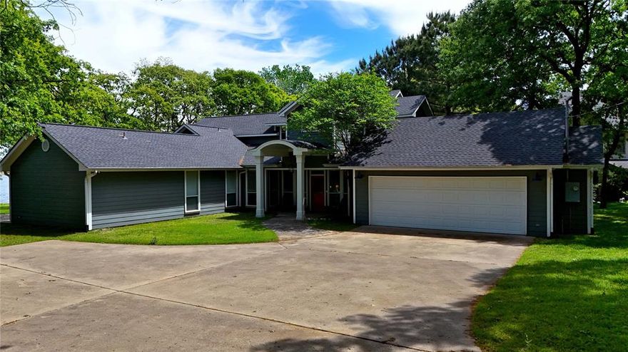 This stunning lakefront estate offers the ultimate in comfort, space, and waterfront living. Featuring 5 bedrooms and 4 bathrooms across 3,994 sq. ft., the home boasts approximately 250 feet of shoreline in a quiet, low-traffic area near the Lake Athens dam—providing privacy and breathtaking views. Designed for both everyday living and entertaining, the open-concept living room flows seamlessly into the kitchen, complete with granite countertops, a pantry, and electric appliances. A separate sitting room with a fireplace showcases beautiful lake views, while abundant storage and closet space are found throughout the home. Two private primary suites—each with walk-in closets and en-suite baths—offer flexibility for guests or multi-generational living. Outdoor living is just as impressive, with a covered back porch, fire pit by the water, and incredible views from nearly every angle. The two-story boat dock includes a boat lift and ample seating, making it ideal for entertaining family and friends. Additional features include a loft area perfect for a second living space or bunk room, a spacious utility room, a large two-car garage, and a new retaining wall completed in 2024. Perfect for large families, hosting unforgettable gatherings, or simply enjoying peaceful lake life, this exceptional property delivers luxury, privacy, and unforgettable waterfront experiences.