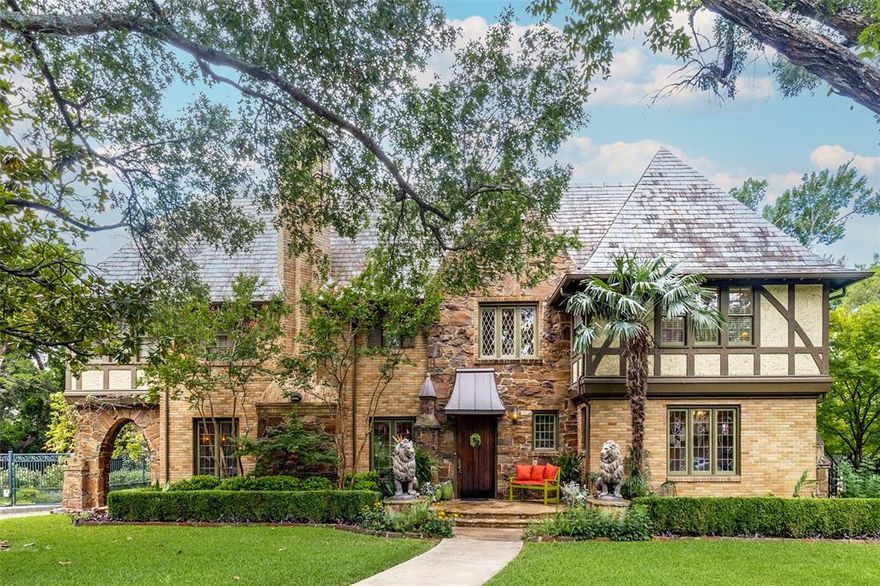 This breathtaking property features one of Kessler Park's most architecturally significant homes, located on a coveted half-acre lot. This handsome Tudor-style residence exemplifies style and craftsmanship like no other. Built in 1928 with a focus on sophisticated elegance, the home boasts timeless features, including a stunning brick, stone, and stucco exterior with half-timbering, a slate roof, decorative overhangs, and original leaded-glass windows.
The interior is equally impressive, offering grand room sizes, ornate trim work, quarter-sawn oak floors through much of the home, and elegant fixtures. The kitchen has been updated to include ample storage and workspace, as well as a gorgeous breakfast area featuring built-in elements and large leaded-glass windows that overlook the grounds. All three bedrooms are spacious, and the master suite features a private office with built-in shelving and a desk, as well as an en-suite bathroom.
 The exquisite terraced backyard, unlike any other, exemplifies the unique beauty and grandeur of this property, featuring custom stone work. Notable highlights include the 17x30 stone gazebo with a kitchen, fireplace, cathedral ceiling, and stunning views of the beautiful gardens and the Italian-inspired pool. Stone columns and an iron fence replicate the home's architectural style. A premier location just a block from Stevens Park golf course, Combs Creek trail, and close to the Bishop Arts district.