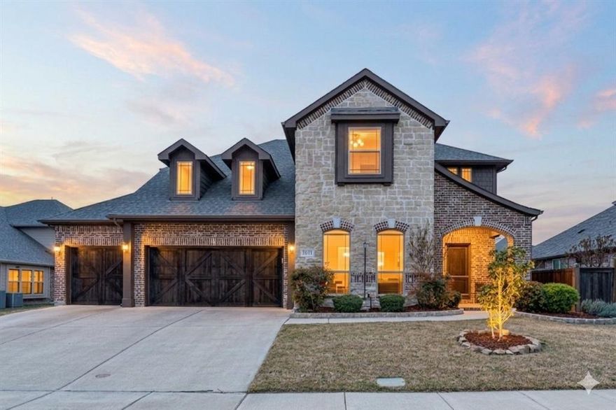 1011 Walford Drive is a 5-bedroom, 5-bath home in Forney with the kind of layout that makes multigenerational living actually work. The primary suite is downstairs. A generous 2nd primary bedroom upstairs. Plus, a 3rd en-suite bedroom provides everyone with space. The study is right next to a full bath, which means a 6th bedroom is an easy option. Rich hardwood floors run through every living area downstairs, anchored by a floor-to-ceiling stone fireplace. The kitchen is exactly what you want it to be: white raised-panel cabinetry, granite countertops, stainless steel appliances, including a gas cooktop and a huge island. Two living areas give the household room to breathe. The three-car garage gives the vehicles the same courtesy. Out back is where this home separates itself. The yard is genuinely oversized, with plenty of room for a pool and still have room for a yard. A timber pergola with a built-in grill and bartop seating area is already waiting for your first cookout.
Built in 2016 and stretching 3,765 square feet, this home has the space and setup to meet your needs today, plus room to grow. The HOA adds a community pool, clubhouse, and tennis courts to sweeten the deal.