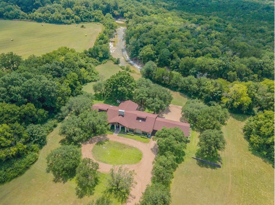 Rare opportunity to own 22.41 acres of prime real estate in Lancaster, perfectly positioned just one mile from I-35E. This unique property features stunning frontage on Ten Mile Creek, boasting rolling hills and heavily treed landscapes that offer a private park atmosphere with city convenience. The acreage is strategically split with 17.41 acres zoned Commercial and 5 acres zoned Residential, all supported by existing city water and sewer—making it an ideal canvas for mixed-use development or a sprawling legacy estate. The site includes a solid 3,610 sq. ft. brick home featuring 4 bedrooms and 2.5 baths, complemented by an oversized garage, multiple storage sheds, and a massive equipment barn for machinery and gear. Whether you are looking to capitalize on high-visibility commercial potential or create a secluded retreat minutes from Dallas, this property offers unmatched versatility and natural beauty.