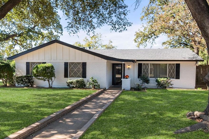 Beautiful .35 acre corner lot with towering oak trees in desirable Pantego, TX, a municipality within the heart of Arlington. If you're a first time homebuyer, investor, or down sizer...bring your own style, vision and expertise and make this wonderful home your own. New roof recently installed and exterior freshly painted. Home features a large family room with fireplace and opens to the spacious kitchen. Additionally, a large bonus living space off the front entry could serve as a home office, formal dining or second living space. This home boasts an oversized, side entry, two car garage with additional covered carport parking. Rare feature for this home...it has its own private well that can be used for yard and garden irrigation without restrictions during times of city water conservation. Large, brick, lofted outbuilding in backyard has electricity and large enough to use as a workshop. Don't miss out on the opportunity to make this house your home!