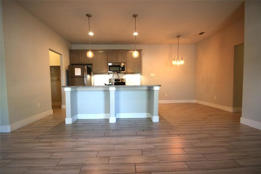 Stunning 3 bedrooms and 2 bathrooms Duplex Home. GREAT Ft Worth Location, SPARKLING Stainless Steel Appliances and Granite Countertops. Beautiful Hardwood Look Tile flooring. Open Gourmet Kitchen plan connected to the living Room. Full Size Washer and Dryer Connections. Spacious Pet Friendly Wood Fenced Yard. Attached are two Car Garage.