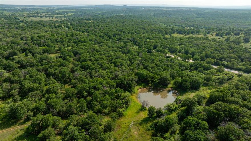 Ammons Take 2 - High Fence Ranch........Seller has made new roads and completed lots of Clearing.
This is a one-of-a-kind property with 503 acres in total, 434 of which is under High fence, and the remaining 69 acres is under low fence, east side of the Creek. The house speaks for itself, Beautiful Kitchen, Fireplace, Game Room in the Loft. Covered Porches and Carport, Storm Cellar. This Ranch has 9 ponds, most have fish and have made it through the last drought. Awesome Hunting!!! Over a mile of lost creek, very pretty bottom ground. Lots of Giant Moss Rocks throughout the property. There are roughly 90 acres of cultivated open fields. These fields are Cross fenced to keep livestock rotating. This ranch is very cattle friendly around the entire 434 acres, with a 30 FT lane between low and high fence, for easy gathering of livestock. Lots of tree cover, Plentiful in post oaks,Elm, and various hard woods. The road system runs right through the entire ranch. This is a Diverse Ranch that will not Disappoint. Inquire about Animals and Exotics... RING US TODAY!