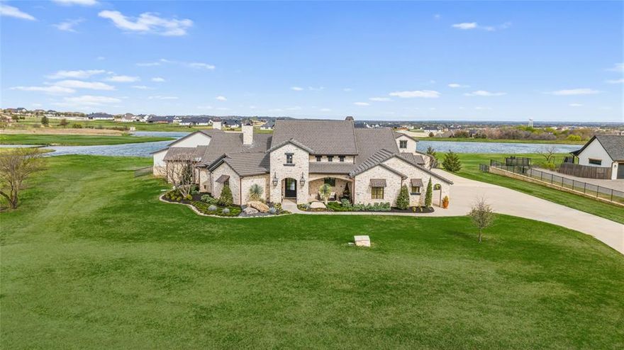 Welcome to an extraordinary custom home in the prestigious gated community of La Madera, where luxury living meets peaceful Texas acreage. Situated on nearly 3 private acres, this stunning 5,000+ square foot home offers the perfect balance of elegant design, modern amenities, and incredible outdoor living.

Inside, timeless craftsmanship shines through with marble floors, hand-scraped hardwoods, and striking distressed heart pine beams. Designer details such as Visual Comfort lighting, grass cloth wallpaper, custom drapery, and Sierra Pacific aluminum-clad windows elevate every space while filling the home with natural light. The main living area centers around a dramatic cast stone fireplace with remote gas starter, creating a warm and inviting place for family and friends to gather.

Built for entertaining, the expansive game and family room features a spectacular wet bar complete with custom brass shelving, True refrigeration, wine coolers, commercial bottle coolers, and multiple ice machines. A whole-home Sonos sound system carries music seamlessly throughout the interior and outdoor spaces.

Step outside to a breathtaking backyard retreat designed to feel like a private resort. The custom pool showcases hand-painted Greek key tile, an in-pool bar table, and a beautiful lueders stone patio, all surrounded by turf landscaping and seamless wrought iron fencing. The outdoor kitchen, with Lynx built-in BBQ, makes hosting under the Texas sky effortless.

Adding to the property’s charm is a private stocked fishing pond and a versatile barn with epoxy floors, full bath, loft, and cedar hunting closet.

This remarkable property offers the rare opportunity to own a true lifestyle estate designed for entertaining, relaxing, and creating lasting family memories.