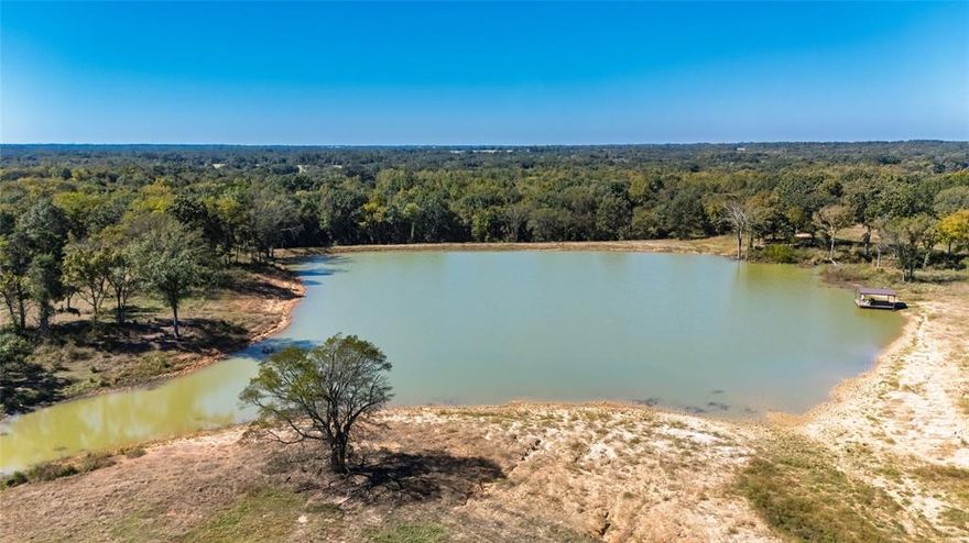 Over 70' elevation changes in this very diversified Ranch and Hunting Property and with over 228 ag exempt acres! Starting on the front of this unique property with custom *FULLY FURNISHED* BARNDO that contains very nice custom spacious living quarters and offers a bonus of 2 additional sleeping quarters with a bathroom & shower  upstairs. Also, a 2nd furnished sitting area (with bar, TV  & shuffleboard table) in the shop for entertaining and enjoyment, the remainder of the shop has 3-12' rollup doors and plenty of space for RV parking, equipment or great working area. There are covered porches to sit and relax looking over a 4 acre lake (covered pier) and over 50 acres of improved meadows surrounding the house with scattered Oaks and rolling hills, a 40x40 custom built horse stable with 3 priefert stalls, horse runs, wash rack, tack room and a  bathroom provide a first class horse facility. There is another barn near the front that offers a place for hay and equipment storage. This area is fenced and cross fenced.  The middle section of this property offers rolling hardwood, cedar and natural growth that has several scattered openings that are good for some additional grazing or the perfect place for food plots and wildlife management area. There are several seasonal natural water spots that would make some great managed duck sloughs. The back of the property is a hunters paradise with Greenwood Creek and Big Creek crossing the property and providing some of the best hunting in East Texas. This property is one that covers it all from weekend getaway, hunting property, livestock facility, corporate retreat, recreational use or the future site of that new custom home. Located only 1 mile from I30 (with good roads), only 17 miles from Sulphur Springs, 5 miles from Mt Vernon and only 90 min. from DFW area provides quick and easy access to this great retreat. Property is bordered by larger ranches to minimize the encroachment and provide privacy while hunting & enjoying