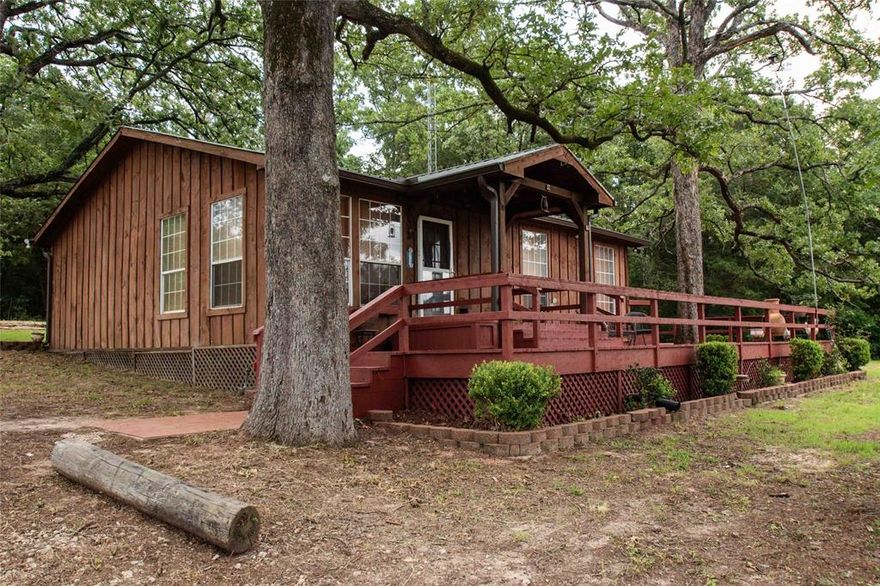 Magnificent weekend get-a-way with wrap-around porch overlooking the lake and pasture with cattle. This two bedroom cabin if off the road and feels secluded.  There is a barn and two other buildings.  If you are an investor who is looking for a speculation opportunity, this 22 + acres is on the I-20 service road right out of Van and across the interstate from the hotel.

.