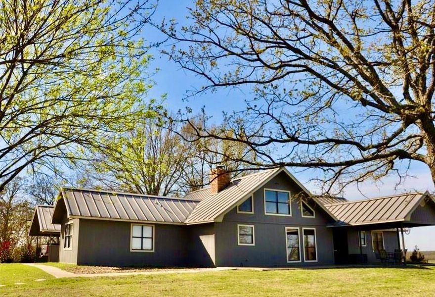 Breathtaking views of the grassy pastures greet you as you approach this hillside ranch with nearly 200 acres! Sit on the hilltop porch just steps away from the 6-acre clear-blue fishing lake and enjoy the scenery. Inside the farmhouse, there are 2 bedrooms plus a bonus room (currently used as a 3rd bedroom). The living room includes a wood-burning fireplace. The kitchen and bathrooms have been updated. Two covered porches give you lots of room for reclining outdoors. An 18x100 workshop with a wood-burning stove gives you a fantastic hobby space. All this on a private setting on a dead-end road near Cooper Lake State Park!