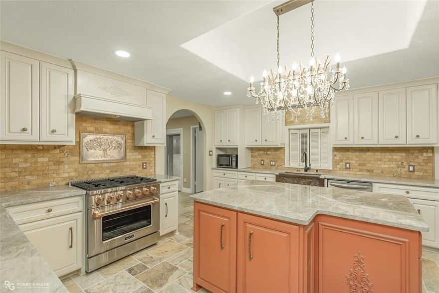 Wow!! Spacious Princeton Property with Acreage, Luxury Upgrades & Exceptional Convenience! Discover the perfect blend of luxury living & country space with this beautifully updated home located just minutes from I-20, & 10 minutes to Bossier City. This property offers the ideal combination of location, craftsmanship, & acreage! Step inside to an impressive chef’s kitchen featuring custom cabinetry, an Akicon gas stove, stainless steel appliances, a spacious center island, & exotic granite countertops. The kitchen is truly a showpiece with its copper farm sink, coffee station, breakfast area & designated dining just of the front entry! This home offers multiple living areas—including a spacious living room with fireplace and a cozy family room ideal for movie nights or game days. The flooring throughout consists of Tuscany tumbled travertine marble pavers. The primary suite offers exceptional comfort with his-and-hers bathrooms, with hers featuring a gorgeous soaking tub & a massive custom walk-in closet that could easily be converted back into a 4th bedroom, if desired. Additional standout features include the Murano glass sink—located in the middle bath. Your half bath boast a specially designed grooming station for your furry friends! Talk about wow! Outside, this property continues to impress. The massive 3-car garage, expansive acreage, and multiple outbuildings offer unlimited possibilities for storage, hobbies, equipment, or recreational needs. Outbuildings include two 30×30 buildings, making this a dream setup for anyone needing extra workspace. This is the kind of property that works hard for you—plenty of space, a solid setup, attention to detail throughout & a great location, just minutes from Haughton & BAFB! If you want room to live, work, and enjoy a little breathing room, this one is worth a look. Schedule your private showing today.