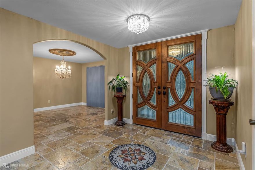 Wow!! Spacious Princeton Property with Acreage, Luxury Upgrades & Exceptional Convenience! Discover the perfect blend of luxury living & country space with this beautifully updated home located just minutes from I-20, & 10 minutes to Bossier City. This property offers the ideal combination of location, craftsmanship, & acreage! Step inside to an impressive chef’s kitchen featuring custom cabinetry, an Akicon gas stove, stainless steel appliances, a spacious center island, & exotic granite countertops. The kitchen is truly a showpiece with its copper farm sink, coffee station, breakfast area & designated dining just of the front entry! This home offers multiple living areas—including a spacious living room with fireplace and a cozy family room ideal for movie nights or game days. The flooring throughout consists of Tuscany tumbled travertine marble pavers. The primary suite offers exceptional comfort with his-and-hers bathrooms, with hers featuring a gorgeous soaking tub & a massive custom walk-in closet that could easily be converted back into a 4th bedroom, if desired. Additional standout features include the Murano glass sink—located in the middle bath. Your half bath boast a specially designed grooming station for your furry friends! Talk about wow! Outside, this property continues to impress. The massive 3-car garage, expansive acreage, and multiple outbuildings offer unlimited possibilities for storage, hobbies, equipment, or recreational needs. Outbuildings include two 30×30 buildings, making this a dream setup for anyone needing extra workspace. This is the kind of property that works hard for you—plenty of space, a solid setup, attention to detail throughout & a great location, just minutes from Haughton & BAFB! If you want room to live, work, and enjoy a little breathing room, this one is worth a look. Schedule your private showing today.