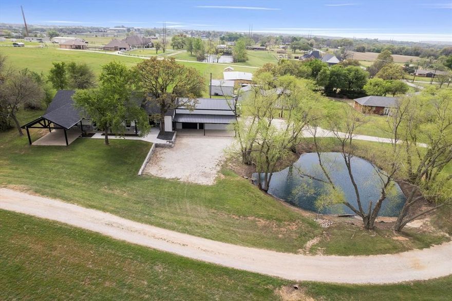 Rate Buy-Down Incentives Available! 
Charming 4-Bedroom Home with Office, Flex Room & Insulated Shop on 1 Acre with Pond in Aubrey, TX

Welcome home to 5480 New Hope Rd, where small-town charm meets modern Texas living. Nestled on a beautiful 1-acre lot with a peaceful pond, this property radiates warmth, comfort, and the kind of heart you can feel the moment you pull into the drive.

Step inside and you’re greeted with an open concept layout designed for connection; where laughter flows from the living room to the kitchen and sunlight dances through every window. The kitchen is the heart of the home, complete with granite countertops, stainless steel appliances, gas range, and abundant storage, perfect for everything from quiet morning coffees to family dinners that stretch into memories.

With 4 spacious bedrooms, 3 full baths, a private office, and a flex room for whatever your life needs next,  this home adapts as your story grows. The primary suite offers peaceful views, a spa-like ensuite, and a large walk-in closet; a personal retreat after long days.

Outside, imagine evenings spent unwinding by the tranquil pond, weekends tinkering or creating in your insulated shop, and wide-open skies that remind you why you love calling Texas home. With no HOA, you have the freedom to make this property truly yours.

Located just minutes from top-rated schools, shopping, and dining, this home offers the perfect blend of country serenity and city convenience; an inviting escape for those craving space, peace, and possibility.