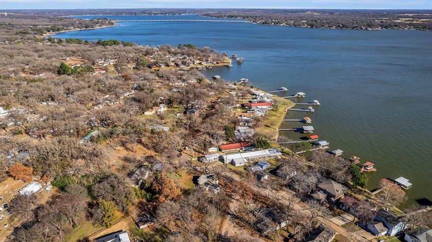 Owner Financing Available. Investor opportunity in Oak Harbor Community! This three bedroom, two bathroom mobile home sits on a desirable corner lot with a water view of Cedar Creek Lake. Features include a wood-burning fireplace in living room addition and access to two boat ramps and a fishing pier in adjoining neighborhood. Property includes three separate lots offering additional development or expansion potential, along with a large, detached storage building. Mobile homes are allowed. The home previously served as a rental and will require new water lines for home, water supply line ready under house with easy access. Needs light fixtures, cabinets, and repairs throughout, making it an excellent value-add investment. Great opportunity for a homeowner looking to renovate, an investor to hold as a rental or redevelop in this established lakeside community. Owner Financing Available