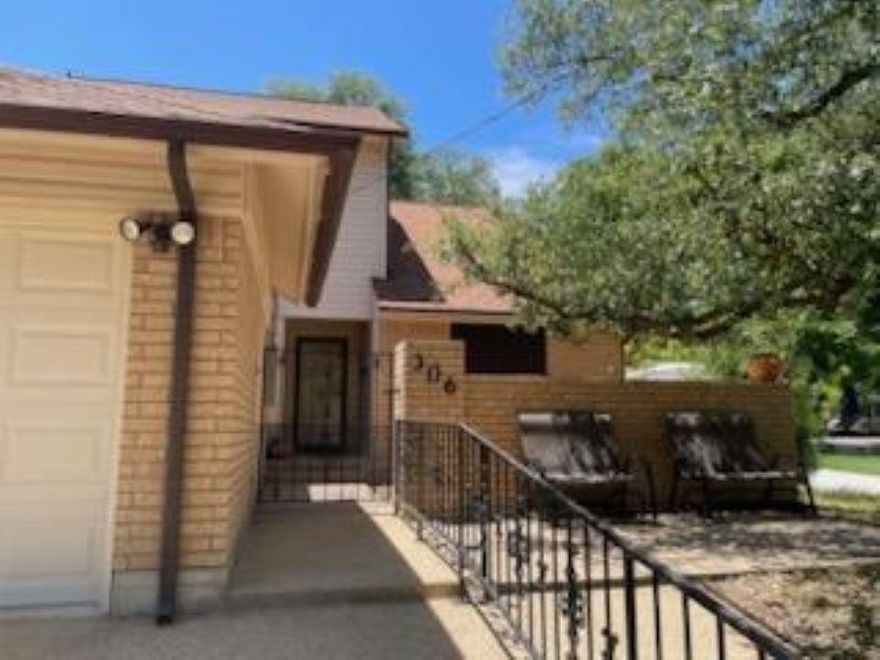 Enjoy the sophistication of this two-story townhouse, located in an established neighborhood of Lampasas. Majestic oak trees canopy the front courtyard as you enter the home. Your eyes are drawn immediately to the mile-high ceilings that adorn the wood-burning fireplace centered on the living room wall.  The beautiful dark wood flooring adds a sense of luxury and warmth to the open space.  A galley-style kitchen offers functionality, along with a quaint eating area overlooking the courtyard filled with natural morning sunshine.  The one-car garage enters directly into the kitchen, providing total convenience when your arms are full. This townhouse offers options when deciding to make the lower or upper bedroom the primary. both have a full bathroom and ample space!  Come take a look today!