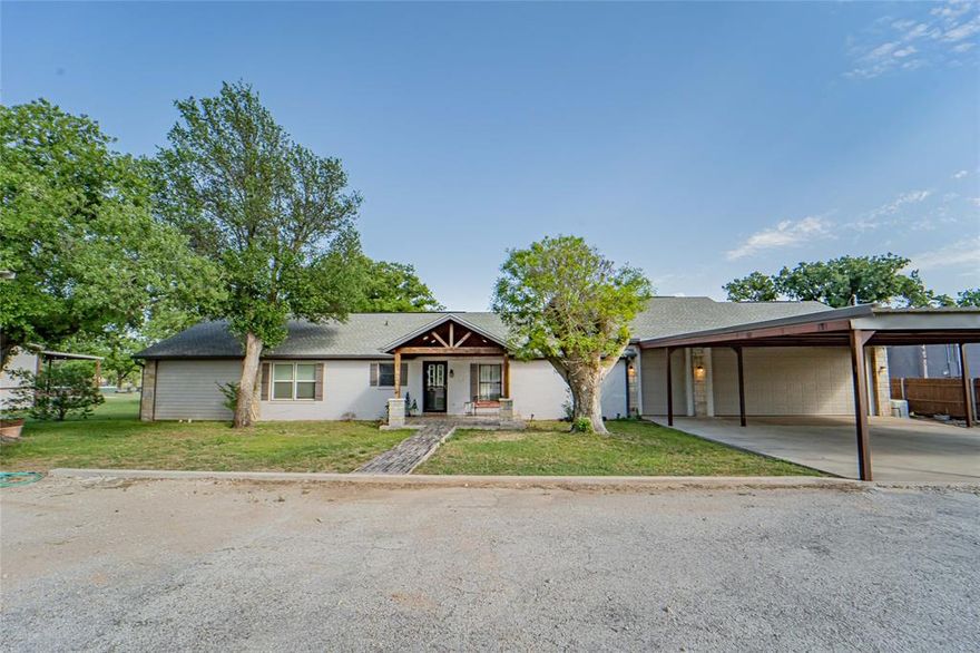 Lakefront Living at Its Best — Now Price Reduced! Experience serene waterfront living on Hubbard Creek Lake in this beautifully appointed 3-bedroom, 3-bath traditional home, offering stunning lake views and effortless outdoor entertaining. Completely move-in ready and fully furnished, this property is perfectly designed for both comfort and resort style living. The open-concept living area features vaulted ceilings and French doors that open to a private patio, creating seamless indoor-outdoor living. The modern kitchen includes granite countertops, stainless steel gas appliances, and generous workspace, flowing effortlessly into the main living areas. Spacious bedrooms and bathrooms showcase custom showers, fresh paint, a tankless water heater, and a large laundry room for added convenience. Outdoor living shines with two private patios, including a fully covered outdoor living space complete with a granite and stone serving bar, ideal for relaxing, entertaining, or enjoying easy lake access for fishing and boating. A standout 3-car garage offers a custom bar with fireplace and game-room setup, mini-split system, 3x10 bonus storage, and room for an additional refrigerator or freezer—perfect for gatherings or hobbies. An attached insulated workroom with electricity and a dedicated fish cleaning station enhances the lake lifestyle. Additional highlights include a whole-home Generac generator for year-round peace of mind and thoughtful updates throughout. Located just minutes from local amenities, this lakefront sanctuary blends everyday convenience with a true resort-style lifestyle. Now priced to sell — don’t miss this exceptional opportunity on Hubbard Creek Lake! Call today and let's unlock YOUR next chapter!