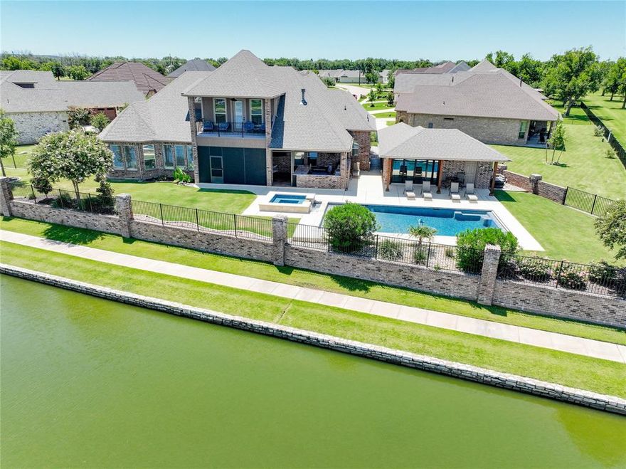 Spectacular custom home nestled on a quiet cul-de-sac with beautiful water views in the desirable Pecan Plantation golf community! This exceptional property offers the perfect blend of luxury and functionality, featuring a heated in-ground gunite pool with fountains, electronic cover, an attached hot tub, plus an approx. 330 sq ft pool house with its own tankless water heater and an 11x15 golf cart garage. Enjoy year-round outdoor living with a screened porch and extended patio space. Inside, the gourmet kitchen is equipped with gorgeous granite, built-in refrigerator & freezer, double ovens and a premium Thermador gas cooktop, ideal for entertaining. Rich hand-scraped wood floors, plantation shutters, and thoughtful design details elevate the interior. The second floor includes a flexible bonus room and a bunk room, offering space for guests, hobbies, or work. The spacious 3-car garage includes walk-up access to a large, floored attic for additional storage. Energy-efficient features include spray foam insulation and two tankless water heaters in the main house. Enjoy all the amenities of Pecan Plantation—golf, tennis, pickleball, parks, equestrian center, airport, clubhouse, and more. This one-of-a-kind home offers an unmatched lifestyle for the entire family!