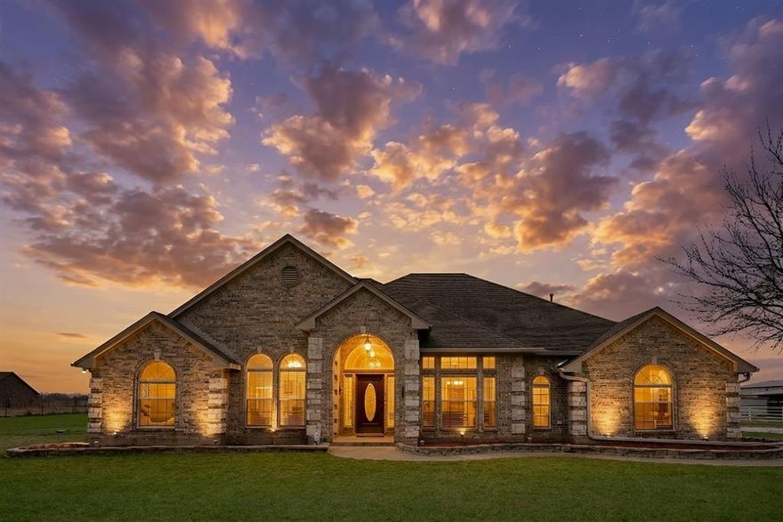 Sitting on over five pristine, acres, this meticulously maintained four bedroom, two bath Cashion Custom home offers refined country living with room to breathe.
Architectural details elevate the interior with soaring vaulted ceilings, elegant curved archways and an atrium-style entry filled with natural light. The open design flows seamlessly into a warm living space anchored by a white rock fireplace and expansive windows framing serene acreage views.
The updated kitchen features custom tile backsplashes, an oversized island, breakfast bar, window seating, and abundant cabinetry. Walk-in closets, built-ins throughout, a central vacuum system, and an oversized utility room with sink and space for an additional refrigerator provide everyday efficiency.
The primary suite offers dual walk-in closets, a spa-inspired bath with slate flooring, jetted soaking tub, oversized shower, and dual vanities.
Outside, the property is fully fenced and cross-fenced with automatic waterers, loafing sheds and a hay barn. Space. Elegance. Freedom.