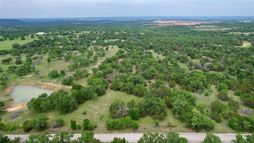 Discover the perfect opportunity to create your own slice of Texas just off Village Bend Rd, approximately 15 minutes south of Mineral Wells and just 15 minutes from Interstate 20. This approximately 8-acre tract offers a beautiful mix of mature oak and cedar, open clearings, and gentle elevation changes that provide long-range views and multiple potential build sites.
A seasonal rock-bottom creek winds through the property, with shaded banks that add both character and a peaceful natural setting. Whether you’re looking to build tucked away among the trees for privacy or take advantage of the elevated views, this property offers the flexibility to bring your vision to life.
The land is currently ag exempt and holds cattle, with fencing in place on three sides (one side in need of repair). Abundant wildlife, good access, and a location outside city limits provide the ideal balance of country living with convenient proximity to town and major highways.
This property is a true blank canvas and will need to be replatted. Currently unimproved with no utilities on site, neighboring properties have access to electricity at the road, offering a clear path for future development.
If you’ve been searching for peaceful acreage with natural beauty, usable land, and room to create something special, this property delivers.
Owner is licensed Texas Real Estate Agent.
Buyer to independently verify all information, including but not limited to acreage, utilities, restrictions, and replatting requirements. Information deemed reliable but not guaranteed. Listing agent and broker make no warranties or representations as to accuracy.