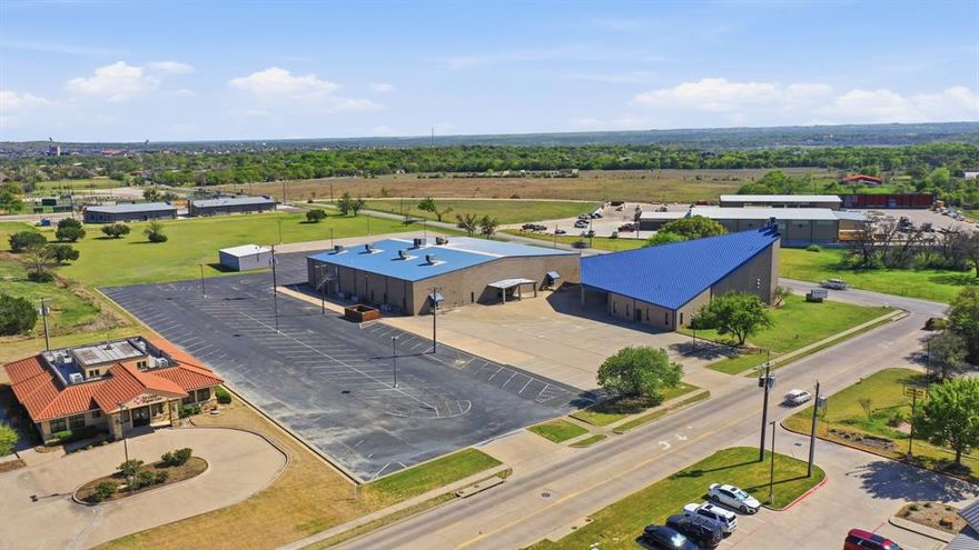 Positioned at one of Willow Park’s most highly traveled intersections, this expansive church campus offers an exceptional opportunity for a growing congregation to establish itself in a visible and well-connected location. Situated at the corner of East Bankhead Highway and South Ranch House Road, the property provides convenient access to Interstate 20 as well as nearby retail, dining, and community amenities, making it easily accessible for members and visitors alike. The campus spans more than 65,000 square feet and has been thoughtfully designed to support a wide range of ministry functions. At its center is an impressive sanctuary of approximately 44,000 square feet, offering a spacious and well-planned layout ideal for large worship gatherings and events. Beyond the sanctuary, the property includes a full gymnasium that lends itself to recreation, fellowship events, and community outreach throughout the week. Additional space on the second level is dedicated to classrooms suitable for all ages, providing flexibility for Sunday school, small groups, and educational programming. The overall design of the campus allows for both large-scale gatherings and day-to-day operations to function seamlessly. After more than 20 years in this location, the current congregation is relocating to accommodate continued growth, creating a rare opportunity for the next organization to step into a fully functional and established campus. With its prominent location, substantial improvements, and versatile layout, this property is well-suited for a church, school, or multi-use facility ready to serve and grow within the Willow Park community.