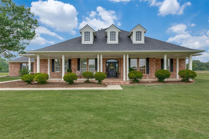 BEAUTIFUL horse country estate consisting of 17.5 acres featuring custom home, 3 outbuildings, gorgeous pond view, & pasture. This property has so much quiet country living to offer without sacrificing the convenience to city amenities & just minutes away from Lake Ray Roberts. The open floor plan allows for a warm, inviting atmosphere, perfect for entertaining. Custom molding, woodwork, built-ins, tray ceilings, plantation shutters, & attention to detail are shown throughout this beautiful, meticulously maintained home. The chef’s kitchen showcases custom wood cabinets, breakfast bar, island, double oven, & built-in refrigerator. The spacious primary suite boasts elegance & luxury with double vanities & walk-in closet in the ensuite bath. The office with private bath offers seamless remote work. A game room offers the versatility of being an extra bedroom. There are 3 outbuildings: an enclosed 2,285 sqft shop with concrete floor & 705 sqft livestock pen, both equipped with electricity & water, plus an open-sided building adds 600 sqft of usable storage for hay or equipment. Enjoy the picturesque views overlooking the expansive backyard, trees & pond. This is a rare find; one you will not want to miss!