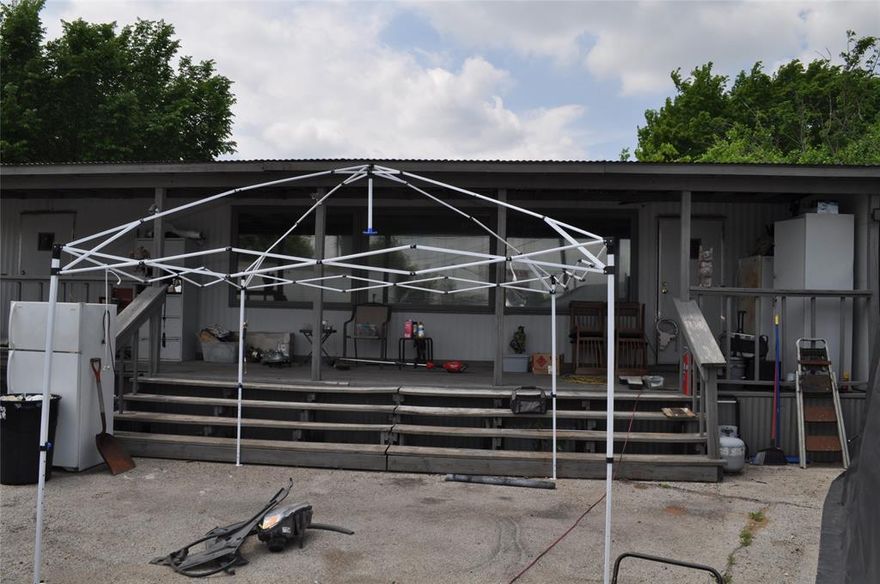 0.423 acres of land, currently used for automotive repair, several trucks parked there, mobile home type office on the property.  Located on Hwy 175 service road.  Currently on a month to month lease.  The property currently has a CO for car lot sales.