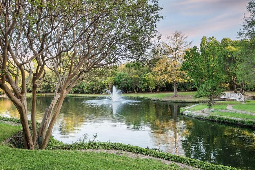 With serene lake and fountain views from every rear-facing window, this stunning 5,537 sq. ft. home offers a harmonious blend of spaciousness, timeless elegance, and soft contemporary finishes. Soaring ceilings and an expansive layout create a sense of grandeur, while thoughtfully curated finishes add inviting warmth and sophistication perfect for everyday living and entertaining. The grand main living areas feature rich hardwood floors, double-sided fireplaces, and seamless connectivity to the well-appointed kitchen.

Thoughtfully positioned to engage with all gathering spaces including the covered porch overlooking the lake, the kitchen boasts a Subzero fridge-freezer, Thermador five-burner cooktop, and double oven, ensuring both style and functionality. An elevator ride leads upstairs to the serene primary suite, a true retreat with a newly remodeled spa-like bath, separate custom closet systems with built-in dressers, dual vanities, and a freestanding tub. Step onto the covered balcony to take in the tranquil lake views. Spacious split guest bedrooms share a full bath, with one bedroom offering balcony access overlooking the water.

Designed for versatility, the home includes a large flex space, used as an office, with custom built-ins and a Subzero beverage fridge, a dry sauna, a theater room, and an oversized storage room with a wine bottle stacking system designed to hold 1,100 bottles. Nestled in the exclusive 15 home enclave of Timberlake Gardens in North Preston Hollow directly across from the Cooper Fitness Center residents enjoy picturesque walking paths, serene sitting areas, and a private gate providing easy access from the lake to the retail shops and dining at Preston and Forest. Conveniently located just minutes from major hospitals, the tollway, highways, luxury shopping, fine dining, and top-tier educational institutions, this home offers an unparalleled lifestyle in one of Dallas' most sought after locations.