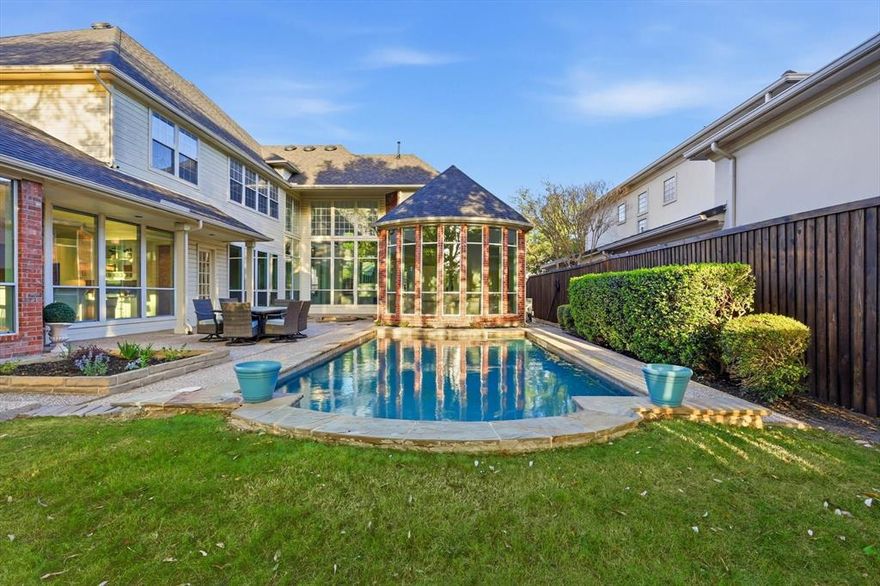 Behind the gates of the prestigious, guard-secured Oakdale community, this exquisitely updated estate offers an exceptional blend of traditional elegance, comfort, security and privacy. A grand, light-filled foyer with soaring ceilings and a curved staircase sets the tone, flanked by a formal living space and richly appointed wood paneled study. Walls of windows frame serene pool views and bathe the main living areas in natural light, creating a seamless connection between indoor sophistication and outdoor tranquility. At the heart of the home, the kitchen opens effortlessly to the family room and breakfast area, designed for both intimate mornings and vibrant entertaining. The primary suite is a true sanctuary, complete with a sitting area and a spa-inspired bath featuring dual vanities, refined finishes, and a generous walk-in closet with shelves and drawers and a built-in cedar closet. A secluded guest suite with private bath offers exceptional comfort for visitors, while an additional downstairs bedroom provides flexibility as a second office or private retreat. Upstairs, dual staircases lead to three spacious bedrooms, two baths, an oversized game room, and a dedicated exercise or media lounge. Amenities include a walk-in pantry, ample storage throughout and two utility rooms - one upstairs and one downstairs. Thoughtfully designed outdoor spaces include a gated sparkling pool and with a separate play yard, allowing children and pets to enjoy their own secure retreat. Residents of Oakdale enjoy picturesque ponds, lush greenbelts, and a sense of community rarely found. Zoned to highly sought-after West Plano schools and minutes from premier private schools, shopping and dining. Extensive recent updates include fully remodeled bathrooms, new carpet, fresh interior paint, a new roof and gutters in 2024, and more. Offering the confidence of modern improvements within a timeless estate setting.