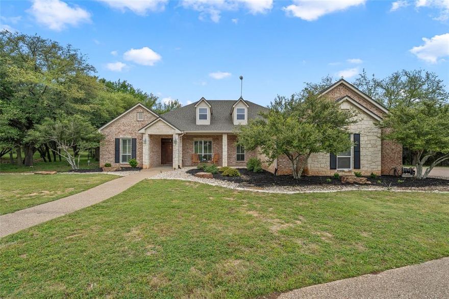 Tucked away on a gorgeous 5.75 acres of mature, tree-covered land with direct access to the Middle Bosque River, this cozy and comfortable home is where peace, privacy, and country charm come together. The 3,820 sq ft home offers 4 bedrooms and 3.5 bathrooms, along a detached garage featuring an additional 2 car garage, large patio and office space that is perfect for work, hobbies, or entertaining. Step outside and soak in the land itself: a half mile walking trail, scenic canopy views overlooking the river, stairs leading down to the water, and a deer feeder where you can sit back and enjoy watching the abundant wildlife wander through. It’s a setting that truly invites you to slow down and savor life. Inside, the open floorplan welcomes you with two spacious living areas, a dining room, and a kitchen designed for gathering—complete with granite countertops, pantry, and a charming breakfast room. The isolated primary suite is a true retreat, featuring private doors to the sun porch, his and hers closets, dual vanities, a walk-in shower, and an oversized soaking tub. With no direct sunlight, it’s the perfect spot for cool, quiet, lazy mornings. An isolated fourth bedroom includes its own full bath, while the other two bedrooms are connected by a Jack-and-Jill bathroom. Additional spaces include a dedicated office, laundry room, and mud room, plus all new carpet throughout. Major systems have been recently updated, offering peace of mind to match the peaceful surroundings. From the home to the land to the river, this special property is a place to experience true peaceful living filled with comfort, joy, and natural beauty.