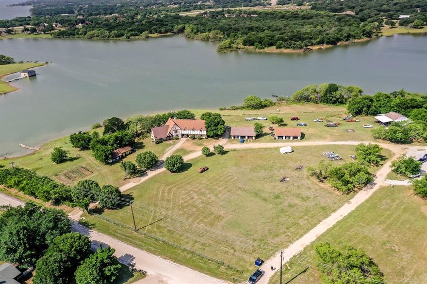 Welcome to your dream property! The value is in the land and its perfect location with great development potential. Situated right on the shores of beautiful Lake Lewisville, this property boasts close to 1000 ft of lakefront. Imagine waking up every morning to stunning views of the water and spending your days fishing, swimming or just soaking up the sun. The best part is that there are no deed restrictions, so you'll have the freedom to make this property your own. Two 30x40 shops sit on the lot, which could make wonderful tiny homes. BONUS -there is already a dock installed. This property offers so many options and flexibility.  We're confident you'll fall in love with it! It's truly a one-of-a-kind opportunity to own a piece of paradise right here in Texas. Newly installed roof as of 9-12-2024. This is one of 3 seperate ways to purchase this piece of Paradise.