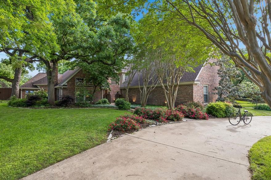 Exceptional Value and recent price improvement on this Jewel in the the Heart of Carroll ISD, located in a voluntary HOA and beautifully updated on a private 1.18 acre lot, features a desirable fabulous mother-in-law suite and esquisite updates! The soaring vaulted ceilings and white oak woodflooring command attetion the moment you step inside. Ample amount of windows flood the living spaces with natural light and an undeniable sense of grandeur. Underfoot, rich white oak hardwood flooring flows seamlessly, grounding the homes elegance with warmth and organic beauty. Thoughtful updates marry timeless architecture with modern refinement. The elegant kitchen features Taj Mahal quartzite and newer appliances. The thoughtfully designed layout features six spacious bedrooms—each with its own ensuite bath—game-room and flex room provide ultimate privacy and convenience. One of the bedrooms can easily function as a dedicated home office to suit your lifestyle needs.  The mother-in-law suite makes this home ideal for multi-generational living or hosting long-term guests. Situated on a stunning 1+ acre lot, the property is surrounded by mature trees—many of them flowering—creating a serene and picturesque setting. The professionally landscaped grounds showcase a variety of established perennials, offering year-round color and charm.  Located in the highly sought-after Cross Timber Hills neighborhood and within the top-rated Carroll ISD, this home offers both prestige and an outstanding community setting.  This is a rare opportunity to own a truly special home that combines modern updates with timeless natural beauty.
