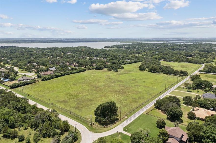 Endless Potential Awaits on 24.56 Pristine Acres in Flower Mound! This land is ready to be platted with the city! This exceptional 24-acre property offers a rare opportunity for visionary developers or those seeking to create a one-of-a-kind private estate. Nestled in the highly sought-after LISD Flower Mound school zone—just minutes from Liberty Christian—this land is primed for a future of luxury and lifestyle. Whether you envision a thoughtfully planned residential community or a secluded, nature-filled retreat, the possibilities are endless. The land is graced with mature native trees, wildflowers, and a natural creek, creating a serene, park-like setting that's truly unmatched. Imagine crafting a subdivision where every homesite is surrounded by lush greenery, native wildlife, and scenic views—or keeping it all for yourself as a private haven designed to reflect your unique vision. Located just a short walk from a private beach and equestrian trail, outdoor adventures are right at your doorstep. Plus, with excellent access to Wichita Trail and Shiloh Road, commuting and connectivity are effortless. Whether you're a builder, investor, or someone looking for their own slice of paradise—this is your blank canvas. In addition to its current residential appeal, this property is undergoing the entitlement process for a potential residential community, offering buyers the rare opportunity to secure land with strong future development potential in a high-growth corridor. All entitlements, zoning, and approvals are in process and not yet finalized; buyer and buyer’s agent to verify all information and development feasibility with the City. Come explore the possibilities and let your imagination take root.