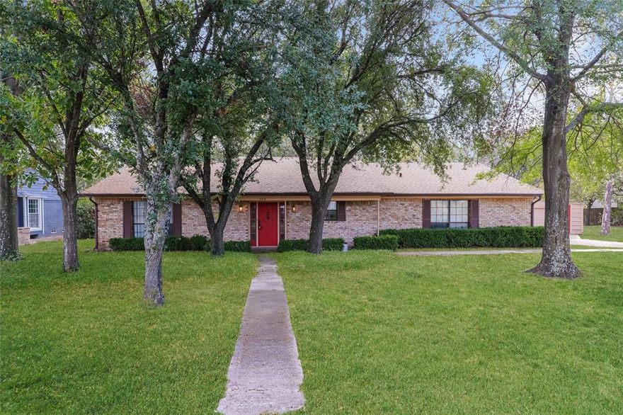 This charming single-family home for lease at 534 Aspendale Dr, Dallas, TX 75253, offers 3 bedrooms and 3 full bathrooms within its comfortable 1,950 square feet. It sits on a huge, private, wooded 1.11-acre lot, giving you plenty of outdoor space and privacy. Built in 1983, the home features a classic brick exterior and inside, the main room feels cozy with high ceilings, wood-paneled walls, and a nice brick fireplace. You'll find a covered back deck perfect for relaxing and grilling, and the property includes an attached garage, and a carport for parking.