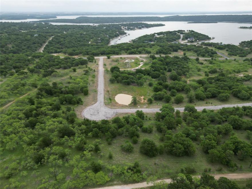 1.509 acres in North Star Pointe, a private gated community on Lake Bridgeport. Interior cul-de-sac lot with mature trees, gentle elevation, and potential for elevated lake views. Build now or later with full access to HOA-maintained amenities, including a private boat ramp, community pool, sports courts, and secure gated entry. Enjoy abundant wildlife, fishing, boating, water sports, and year-round outdoor recreation. A great opportunity to own acreage in a well-kept lake community with space, privacy, and a relaxed lifestyle setting.