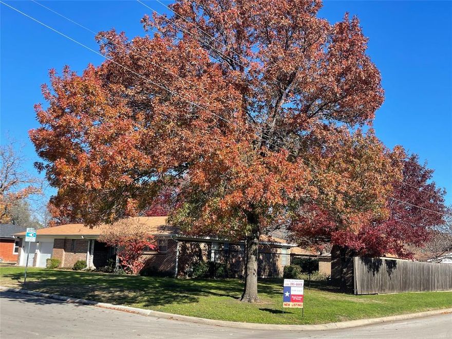 CORNER LOT with beautiful Red Oaks, huge Pecan Tree and Crepe Myrtles.  Entrance on Side to accommodate vehicle access to back yard and small Shop.  Yard is also large enough for a Swimming Pool. Covered 13 x20 Patio Deck with additional concrete Patio of 16x21 with sidewalks.
Inside, lovingly maintained, Open Living, Dining, Kitchen with adorable Vintage tiled counters in Kitchen & Bath.  Lots of light and exudes home!
Focus on the nostalgia and move on in!  Easy Access from 820 to anywhere in the Metroplex!