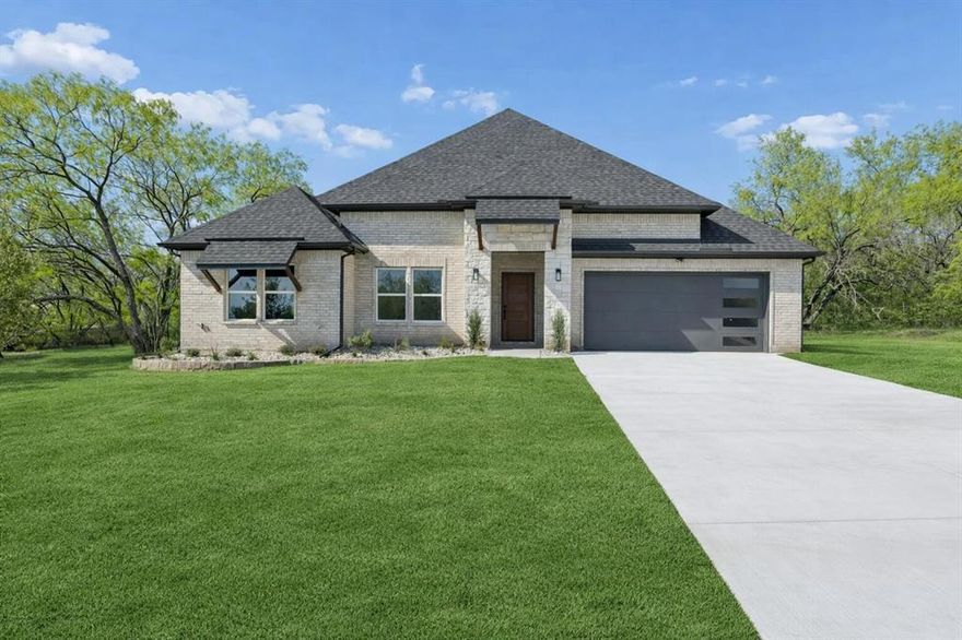 Welcome to 98 Roberts Run — a stunning new construction in Sherman's desirable Preston Club community. This single-story 4-bed-3-bath home delivers 2,266 sq ft of thoughtfully designed living space under soaring 12-ft ceilings, with 3,013 sq ft total under roof on a 9,995 sq ft (~0.23-acre) lot, plus a 442 sq ft 2-car garage with an oversized extended 34x18 driveway — plenty of room for guests.
The open-concept layout centers on a show-stopping chef's kitchen featuring quartz countertops, an oversized island with seating for 4, a 36 5-burner electric cooktop, 30 wall oven, built-in microwave, dishwasher with 3rd rack, walk-in pantry, ceramic backsplash, 32 black stainless workstation sink, and a pass-through window to the outdoor kitchen. The spacious living area features a sleek modern electric fireplace beneath soaring 12-ft ceilings and recessed lighting throughout.
The primary suite (15x17) has 10-ft ceilings and a spa-inspired bath with double vanity, makeup vanity, 59 soaking tub with matte black fixtures, walk-in shower with marble-look tile, and non-slip mosaic flooring. Secondary bedrooms feature 9-ft ceilings and generous closets. All 3 bathrooms finished to the same high standard.
Step outside to a fully equipped outdoor entertaining space: 305 sq ft covered patio with remote-control ceiling fan, complete outdoor kitchen with 5-burner grill with rear burner, vent hood, prep sink, stainless trash drawer with sliding rails, storage panels, and a 6-ft privacy fence.
Built for efficiency: Carrier 4-ton HVAC, spray foam insulation, double-pane windows, 30-yr roof, gutters, full irrigation, and exterior LED security lighting. HOA only $402.41-yr — one of the lowest in the area! Sherman ISD schools.
Builder warranty: 1-yr workmanship  2-yr systems  10-yr structural.