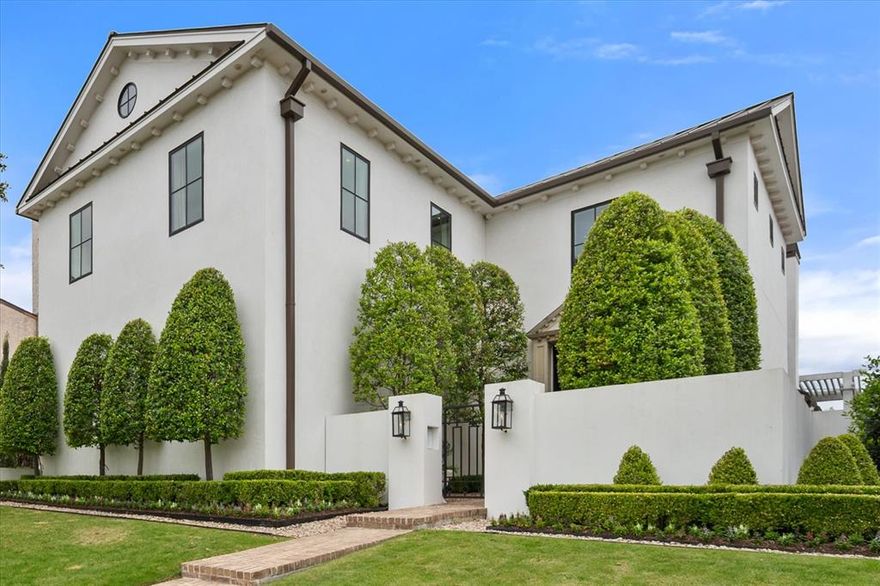 Set within Riverhills Phase 2, this thoughtfully designed residence pairs elevated finishes with a layout that lives beautifully for both everyday use and entertaining. With the primary suite positioned on the main level and all secondary bedrooms plus a spacious playroom upstairs, the floor plan offers a smart separation of space while maintaining an easy, connected flow. Just off the primary, a private TV room creates a quiet retreat—ideal for unwinding without leaving the main level. The heart of the home is anchored by a well-appointed main kitchen featuring a Wolf range, complemented by a fully equipped prep kitchen that keeps everything running seamlessly behind the scenes. A stylish wet bar with generous wine storage adds another layer of functionality for hosting. The main living area is filled with natural light and connects effortlessly to the outdoors, with two sets of double Marvin doors opening to the backyard, along with an additional set of doors in the dining room that further enhances the indoor-outdoor flow. Throughout, high-end designer finishes—including Schumacher wallpaper—bring depth and character, while 11-foot ceilings (and 13 feet in the dining room) enhance the sense of scale and light. Quality construction is evident at every turn, with carefully considered details that elevate the overall experience. Outdoor living is just as compelling, with a turfed backyard and putting green designed for both recreation and low-maintenance enjoyment. The rooftop patio offers an additional entertaining space, capturing wide-reaching views over Fort Worth and creating a setting that feels both relaxed and refined. Complete with a three-car garage and ideally located just a quick drive to Fort Worth Country Day School and Waterside’s dining and shopping, this home delivers a well-balanced combination of design, functionality, and location in one of Fort Worth’s most sought-after areas.