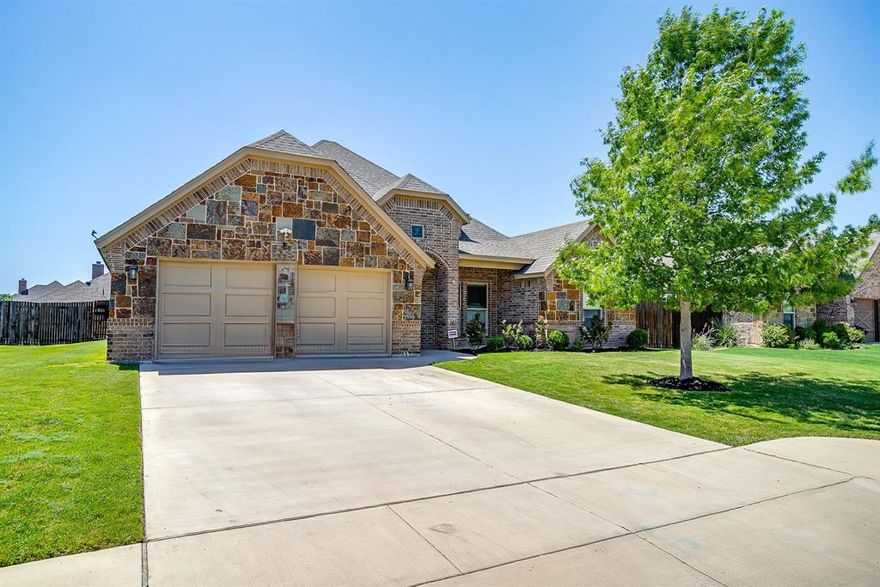 Welcome to this 3-bedroom beauty in the coveted Aledo ISD complete with a dedicated office space! This timeless designed home has sought-after features such as hand-scraped hardwood flooring and an open floor plan, providing a spacious and welcoming atmosphere. The living area is LARGE with a stone wood-burning fireplace that is open to the kitchen and dining. It is the ultimate entertainment house to host gatherings for events and holidays! The kitchen is tastefully designed with a clean, classic white theme, complemented by black hardware, a stainless steel farmhouse sink, a functional kitchen island, granite countertops, and a smokey grey backsplash. The primary bedroom is well-lit with natural lighting and features dual sinks, a garden bathtub, a separate shower, and a custom closet. The property also includes a large covered back patio, ideal for enjoying the outdoors. The home has been freshly painted and meticulously maintained, ensuring it's ready for immediate move-in. Located conveniently near I-20, this property provides easy access to shopping, dining, and is only a 25-minute drive to Downtown Fort Worth. This home combines style, comfort, and convenience, making it an excellent choice for your next move! Come take a look!