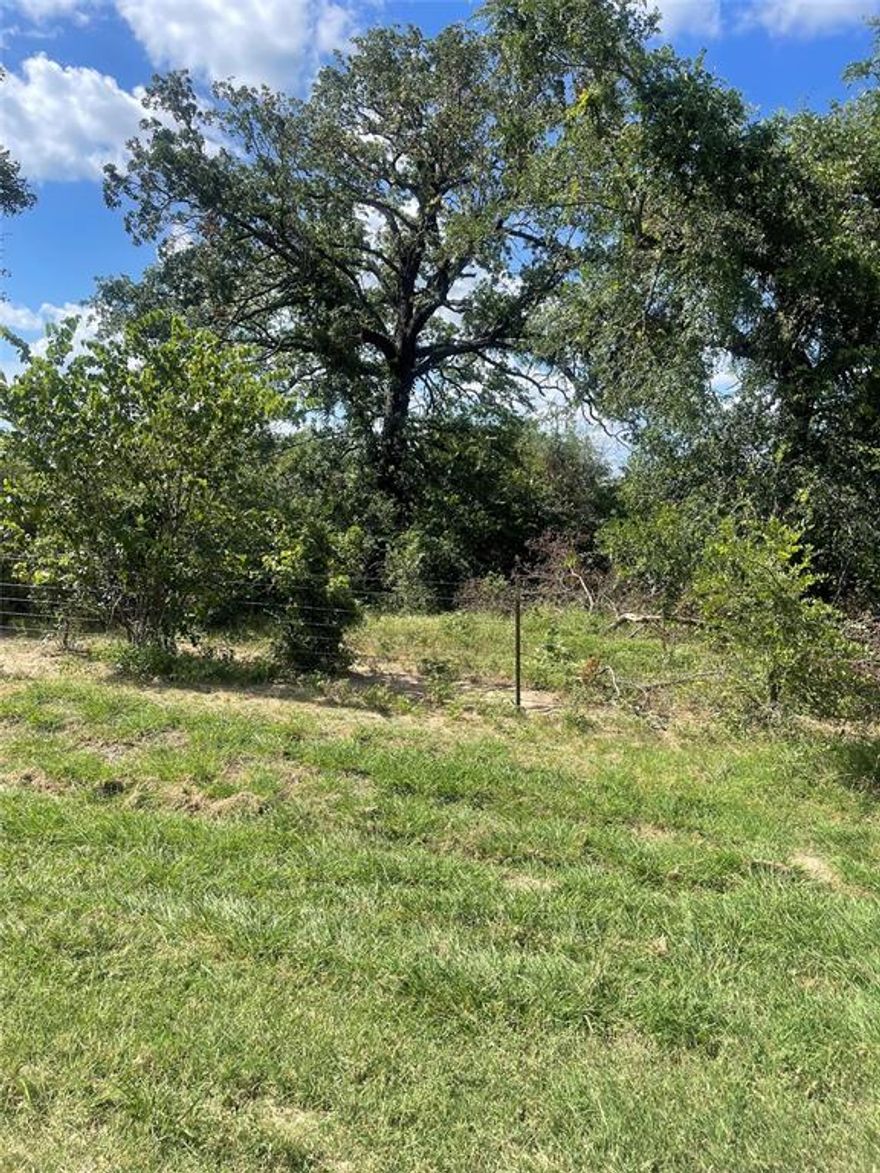 This 7.82 acres is located in the much sought after Paradise ISD.  The property is on a county road that dead ends just past this property.  The acreage is heavily wooded in the front for privacy and there are several acres cleared for pasture.  There are 2 stock tanks on property.  One is near front and a larger one near the back of property.  The barn has 4 stalls with an open middle and there are several pens with pipe fencing to keep livestock separated.  A water well supplies water for the house and barn area and there is a septic system.  The old mobile home on property has no value.