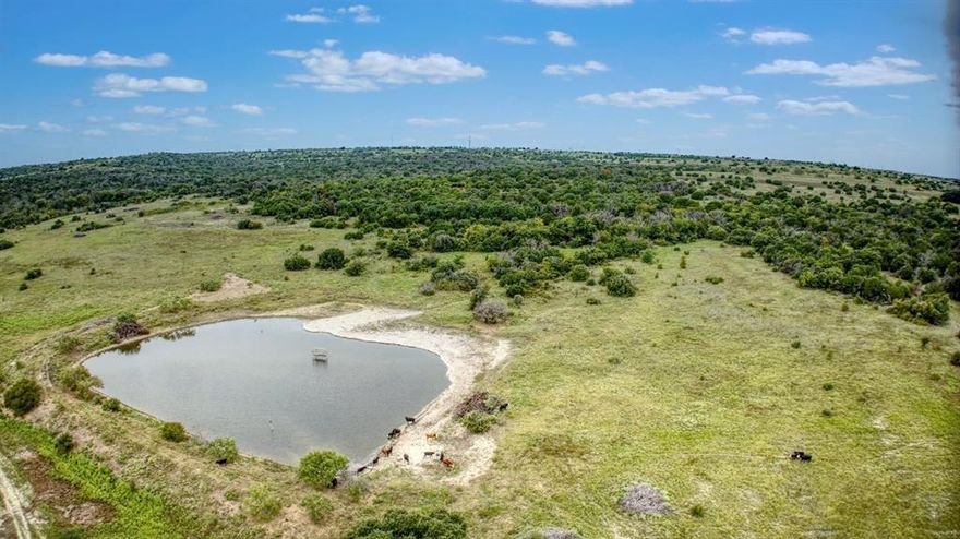 Historic JD Kutch-Elder Ranch – 947± Acres. NE Parker County, Texas This exceptional ranch offers a rare blend of history, natural beauty, and convenience. Ideally located between Weatherford, Springtown, and Azle, with paved frontage on Upper Denton Rd and Veal Station Rd, it’s just 30 minutes from Fort Worth and 5 miles from Lake Weatherford. Situated on one of Parker County’s highest points, the ranch boasts panoramic views—including the Fort Worth skyline. Rolling hills, mature live and red oaks, and abundant water sources including the headwaters of Silver
Creek, Ash Creek, Pecan Creek, natural springs, five stock tanks, and four water wells make this property truly unique. The land is cross-fenced into three main pastures, two holding pastures, and two horse traps, with a 70-acre cultivated field. Native grasses such as Big Bluestem and Indian Grass are thriving due to excellent land stewardship. Wildlife is plentiful—deer, turkey, quail, dove, and duck—offering exceptional recreational and hunting opportunities. Improvements include a 1937 two-story sandstone home full of rustic charm, a large barn, new pipe working pens, a
loading chute, and a 50-ft round pen. Development Potential: With its prime location, extensive road frontage, elevated build sites, and proximity to major growth corridors, the ranch offers outstanding potential for residential or mixed-use development. The combination of natural beauty, utilities, water resources, and accessibility makes this one of the most attractive large-acreage development opportunities remaining in Parker County. Minerals: Seller retains all mineral rights.