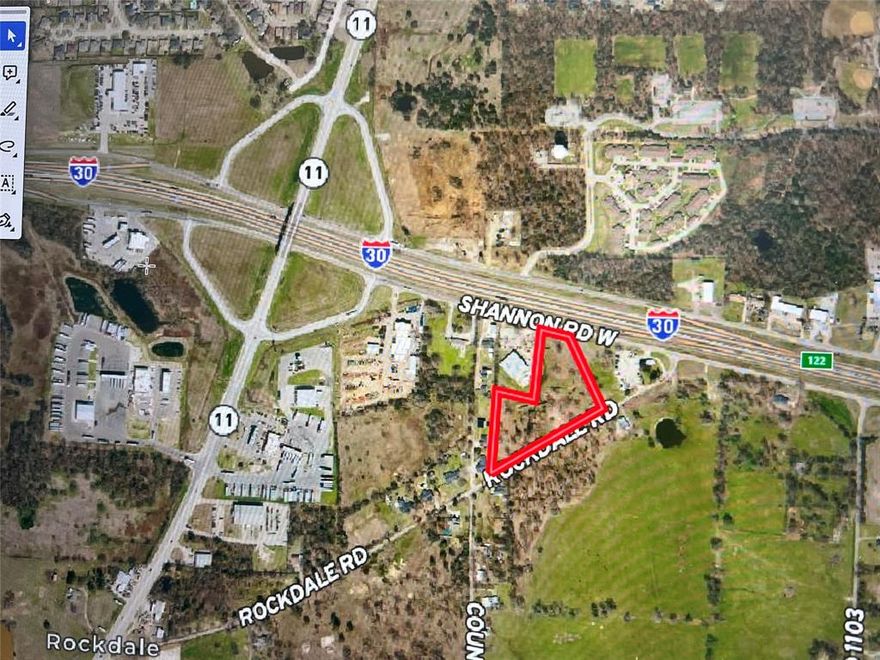 PRIME LOCATION!!  5.4 acres with Interstate 30 frontage located right on the service road, creating great exposure and easy access for a commercial building, storage buildings, or other business. Lots of possibilities with 2 roads for access with the I-30 service road (aka Shannon Road) on the NORTH side AND Rockdale Road (city road) on the SOUTH side. North access includes proximity to eastbound on-ramp which offers high visibility and traffic flow. Established commercial businesses on both sides of I-30 frontage. Or from the south side of the property (Rockdale Road), there is potential for a residential development. The majority of the perimeter is in trees with several trees scattered throughout.  
AADT for on ramp is 3,516
AADT for I-30 is 36,321