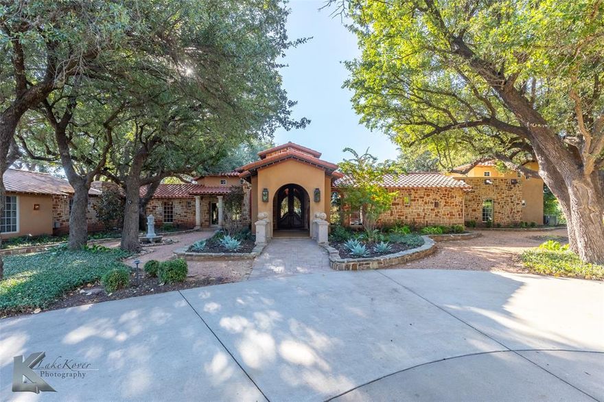 Set across 68 private acres just minutes from the iconic Perini Ranch Steakhouse, this Paradise Road property is a rare legacy estate offering exceptional scale, history, and versatility. Formerly known as Camp Whispering Oaks, this property has evolved into a remarkable residential and recreational compound featuring three residences and an array of amenities seldom found in private ownership.The centerpiece is a 5,315 sq.ft. Mediterranean-style main home, built in 2007 and designed in a graceful horseshoe layout that embraces courtyards, water features, and mature oak trees. Covered porches wrap the home, creating seamless indoor–outdoor living. Walls of windows and doors fill the open-concept living, dining, and entertaining spaces with natural light. The chef’s kitchen anchors the home with a keeping area ideal for gatherings, while a dedicated wine cellar and screened-in sleeping porch elevate the estate’s resort-like appeal.A 4,887 sq.ft. secondary structure, currently utilized as offices, offers exceptional flexibility for guest accommodations, retreat use, or future residential conversion. A third 1,540 sq.ft. guest or caretaker’s home provides additional living space for multigenerational needs or ranch staff.Honoring its storied past, the property includes a rustic barn, former camper cabin structures, and a peaceful cross and worship area nestled beneath the trees. Recreational amenities include an Olympic-size swimming pool (currently drained and awaiting renovation), pool house with restrooms, tennis and basketball courts, and a vintage baseball field—all presenting extraordinary restoration potential.Serviced by well and septic, this estate offers privacy, serenity, and endless opportunity—whether envisioned as a family compound, private retreat, or future venue. The property is a once-in-a-generation offering ready for its next chapter.