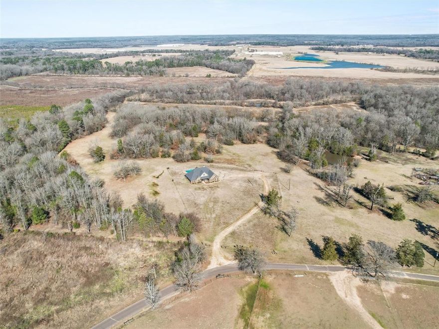 Welcome to your dream home in the heart of Northern Upshur County—where luxury meets tranquility. This stunning custom-built 4-bedroom, 3-bath brick residence offers the perfect blend of elegance and comfort, nestled in a peaceful setting with panoramic views on just under 55 acres. Step inside to an inviting open floor plan ideal for both everyday living and entertaining. The chef’s kitchen is a culinary haven, featuring a gas stove, ample workspace, and premium finishes to inspire your inner gourmet. A thoughtfully designed split-bedroom layout ensures privacy, with the spacious primary suite serving as your personal sanctuary. Step outside to your own resort-style escape. A sparkling gunite pool overlooks scenic landscapes, creating a breathtaking backdrop for morning coffee, evening swims, or weekend gatherings. With upscale finishes, spacious living areas, and easy access to nearby amenities, this home offers the best of both worlds—peaceful country living with modern convenience. Don’t miss this rare opportunity to own a slice of East Texas paradise.