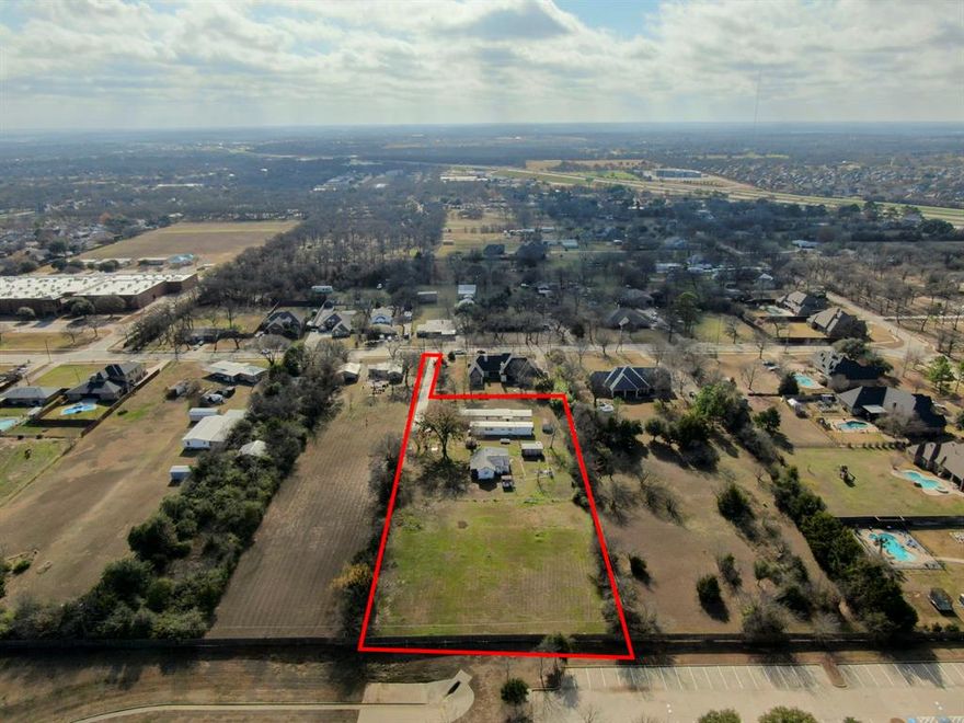 BEAUTIFUL LARGE LOT 1.68 ACRES. Discover an exceptional opportunity in a highly sought-after, quiet enclave surrounded by custom and luxury homes. This beautiful acreage offers mature shade trees, open cleared spaces, and a peaceful setting. The perfect canvas for your future HOMEBUILDING plans. The value here is in the land, yet the property also includes 2 livable, mostly-updated mobile homes that may offer rental income potential while you design and build. The abandoned single-family dwelling on site is not habitable and will need to be demolished and removed; quotes received range from approximately $5,000–$15,000 (buyer to verify). Mobile Home #1 1064 sf features a kitchen, living and dining areas, a primary suite, plus a second bedroom and full bath. Mobile Home #2 744 sf offers a living room, eat-in kitchen with breakfast bar, two bedrooms, and a partially finished bathroom. Both homes have new carpet, refreshed walls, and select updated light fixtures. Utilities and improvements include a water well currently servicing the mobile homes, septic system, propane, electricity, and a long concrete driveway with gated entrance. City water and sewer are available at the street but are not currently connected. Multi-generational living opportunity. Per seller, the property may have the potential to be replatted into (up to) three lots; deed restrictions and City of Arlington building requirements apply. Buyer to conduct all due diligence regarding platting, zoning, subdivision, building requirements, and utility connections. Bring your vision — whether developing, building your dream home, or holding as an investment — this is an incredible tract in a prime location. Showings by appointment only.  Do not view property without an appointment.